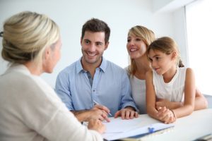 family talking to a real estate agent